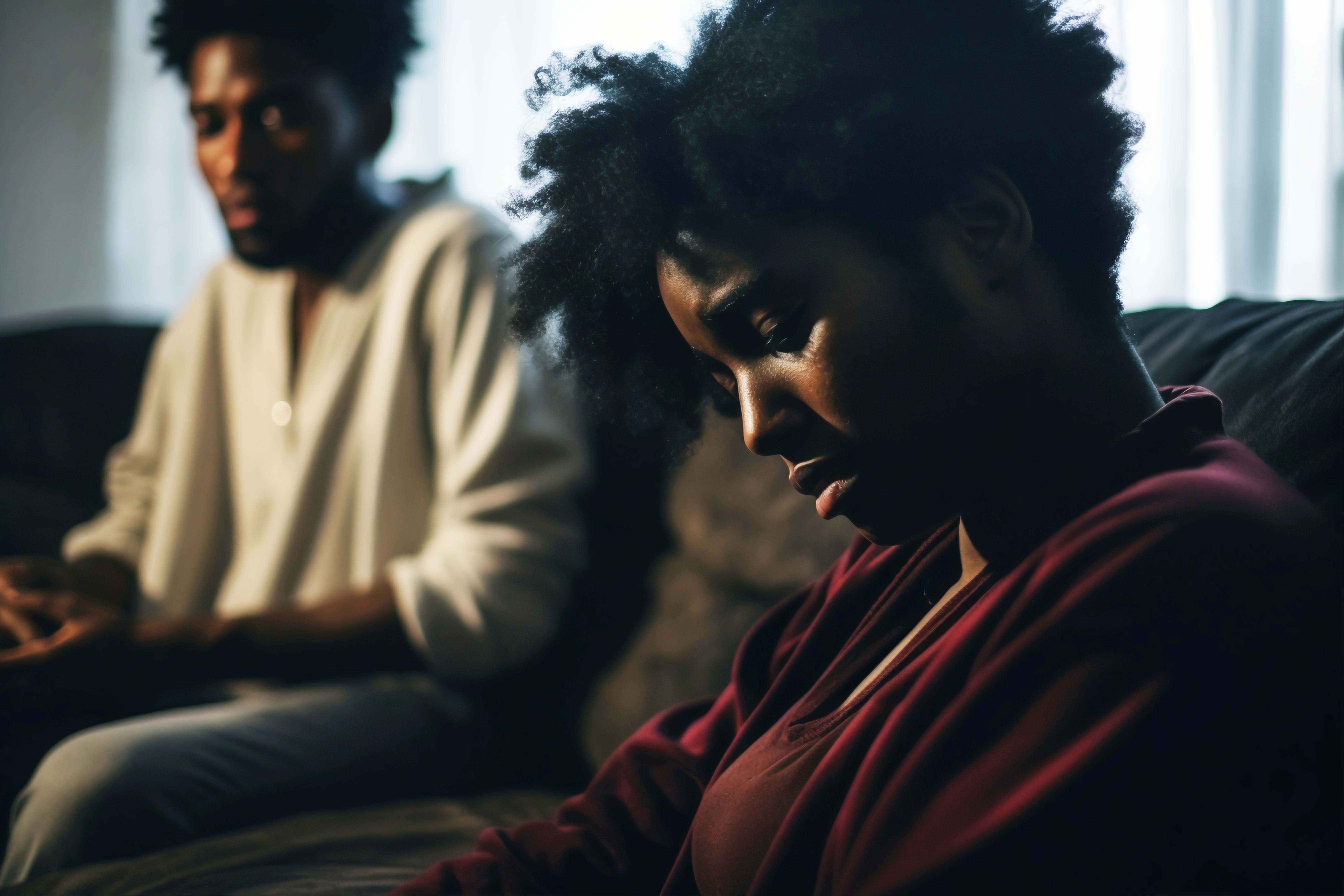 Grief — two people sitting in silence, carrying the weight of loss